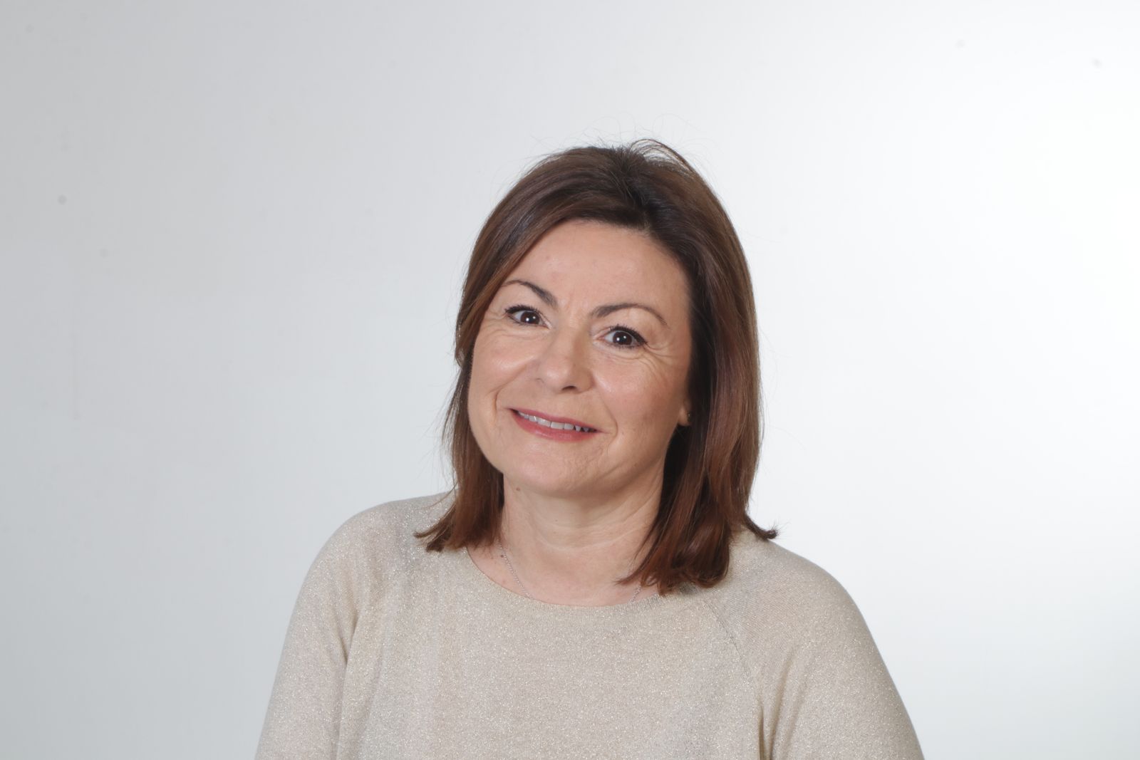 A confident middle-aged teacher smiling
