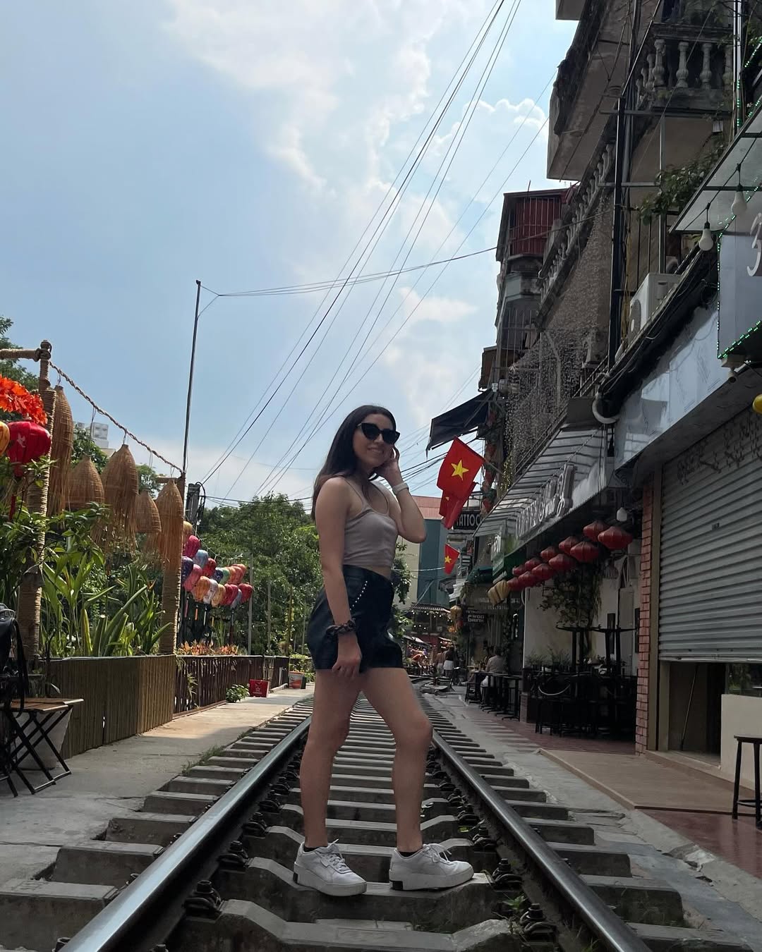 English teacher standing on the famous Hanoi Train Street in Vietnam