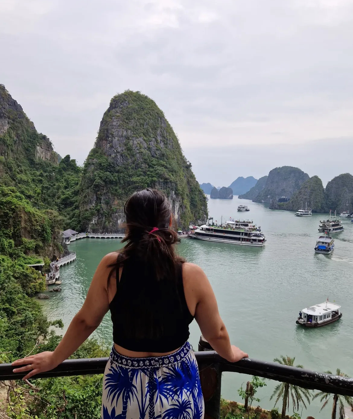 Female teacher overlooking Ha Long Bay limestone islands Vietnam