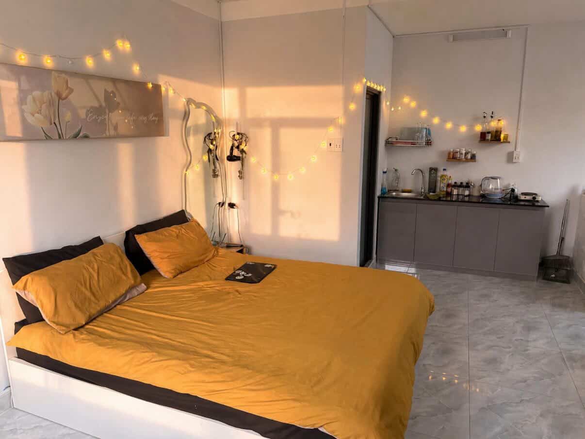 Studio apartment in Phu Nhuan, Ho Chi Minh City — bed and kitchen area