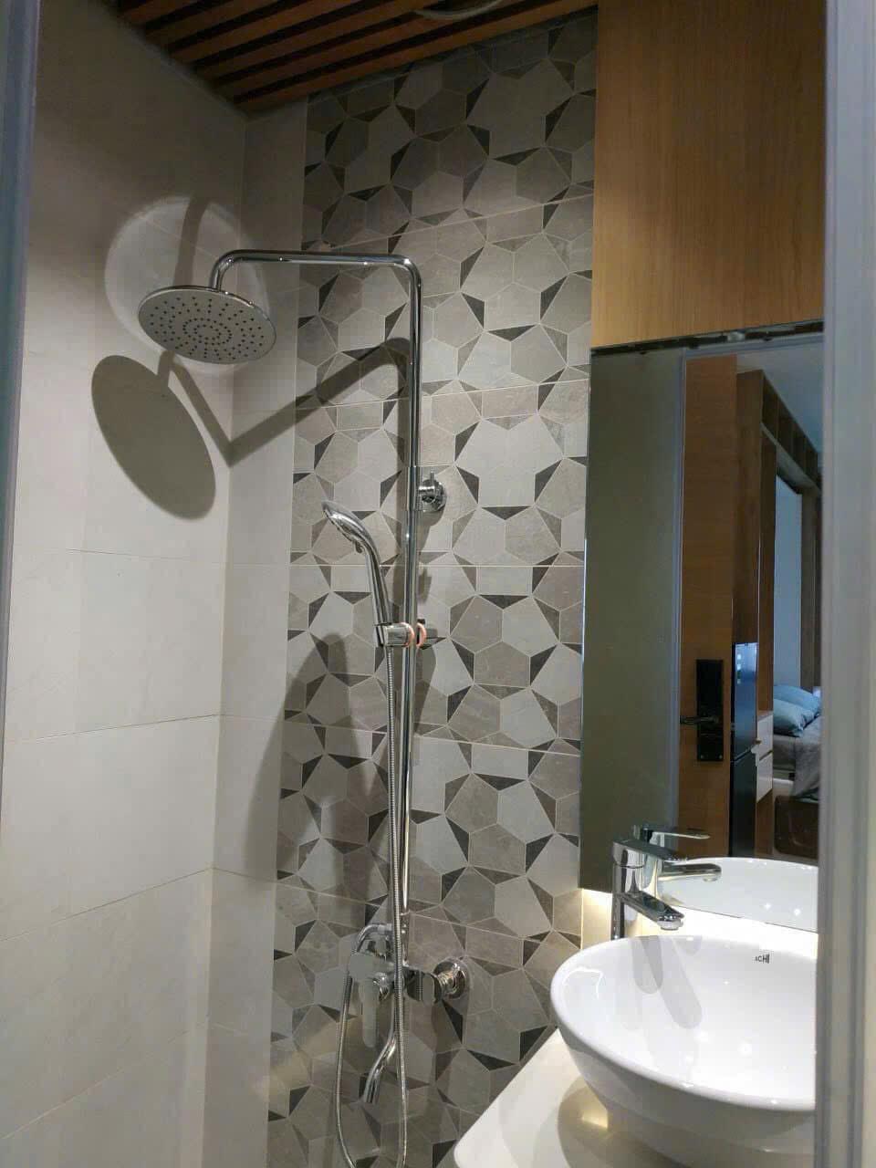 Modern bathroom with geometric tile in a Vietnam teacher apartment