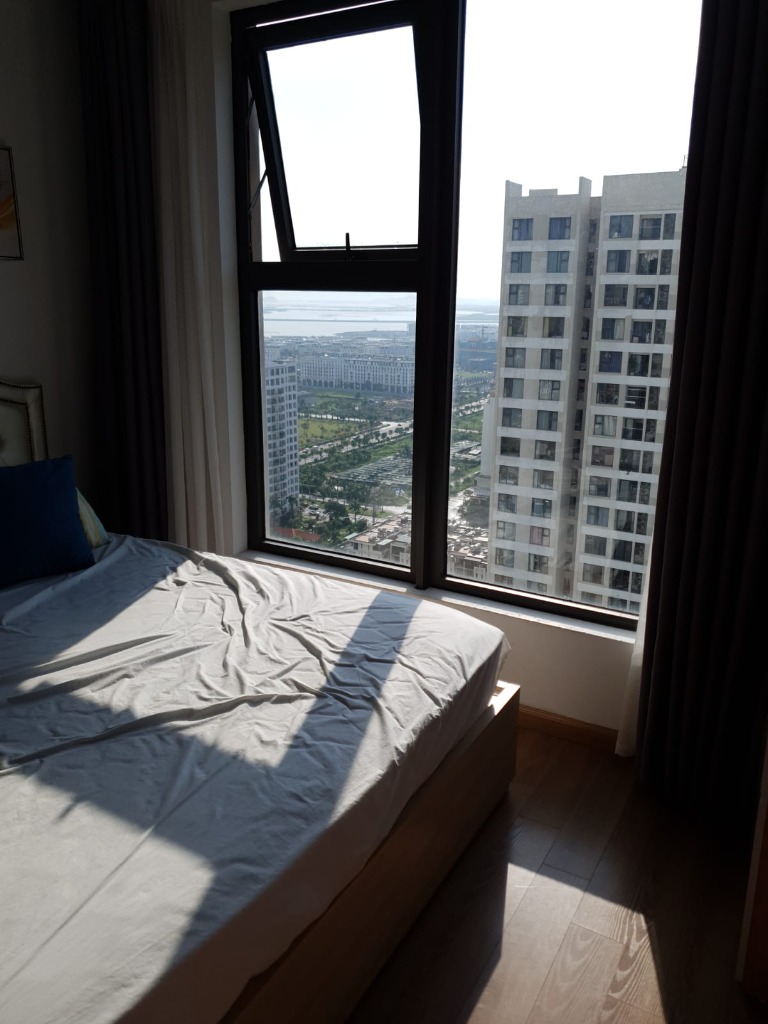 Bedroom with panoramic window view Ha Long Bay Vietnam teacher apartment