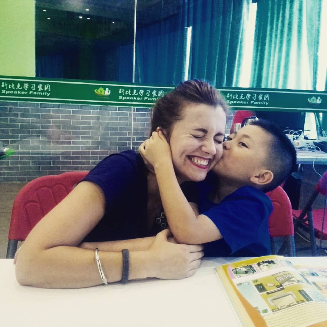 Vietnamese student showing affection to non-native English teacher classroom bond