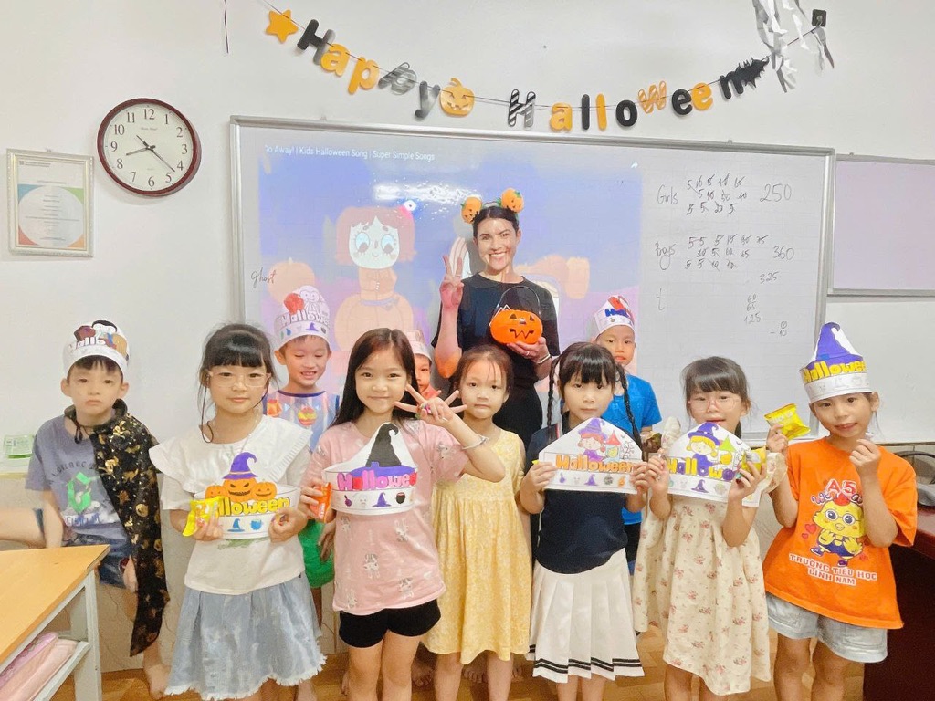 Female English teacher at Halloween event with students at Vietnamese language center