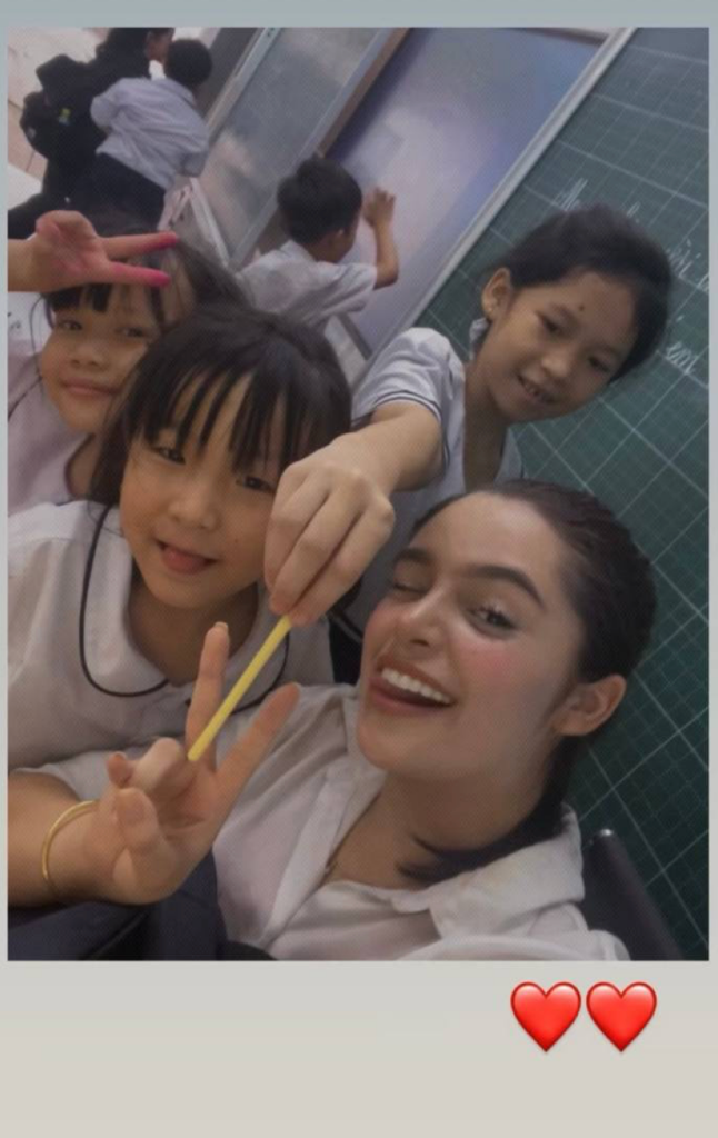 English teacher with students in Vietnam classroom