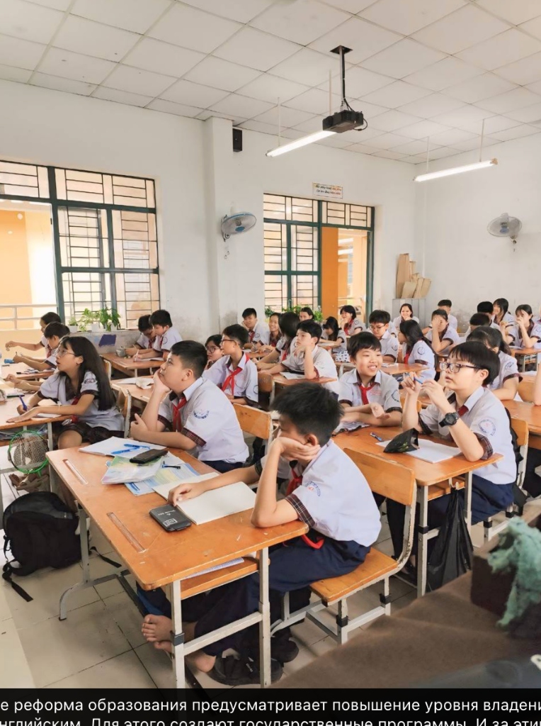 Non-native English teacher in a modern Vietnamese classroom with students — teaching English in Vietnam without a linguistics degree